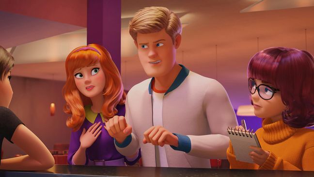 This image released by Warner Bros. Pictures shows, from left, characters Daphne, voiced by Amanda Seyfried, Fred, voiced by Zac Efron and Velma, voiced by Gina Rodriguez, in a scene from the animated film "Scoob!" (Warner Bros. Pictures via AP)