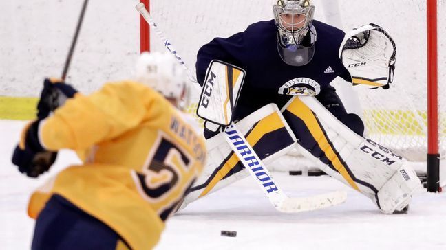 Nashville Predators goalie Pekka Rinne, of Finland, follows a shot by left wing Austin Watson (51) during a practice Monday, April 9, 2018, in Nashville, Tenn. The Predators are scheduled to play the Colorado Avalanche in the first round of the NHL Western Conference hockey playoffs on Thursday. (AP Photo/Mark Humphrey)