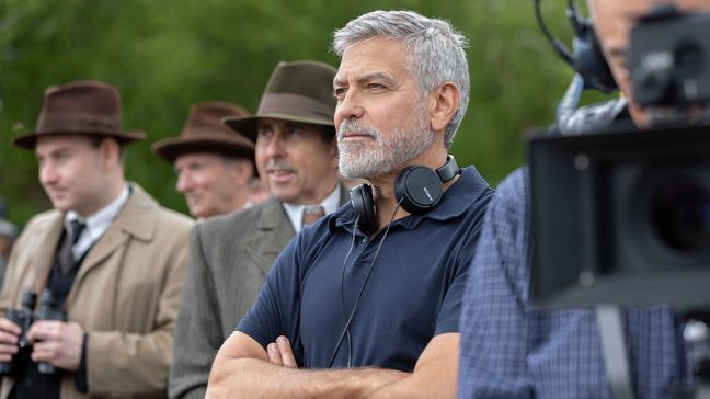 This image released by MGM Pictures shows director George Clooney, center, on the set of "The Boys in the Boat." (Laurie Sparham/Metro-Goldwyn-Mayer Pictures via AP)