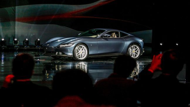 The Ferrari Roma car is unveiled in Rome, Thursday, Nov. 14, 2019. Ferrari unveils a new sports coupe aimed at enticing entry-level buyers and competing with the Porsche 911, part of a complete refresh of its model lineup by 2022. (Fabio Frustaci/ANSA via AP)