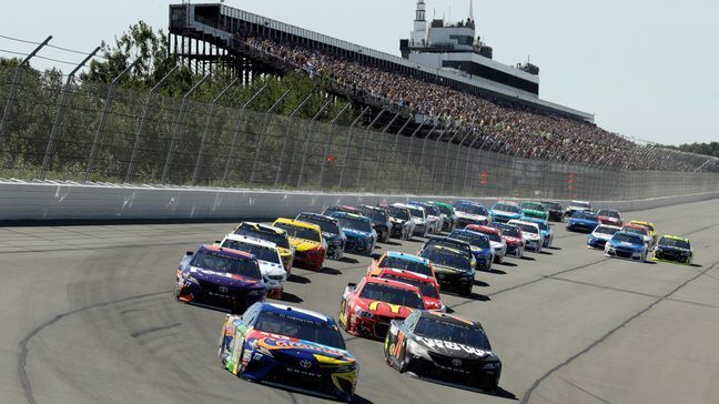 Kyle Busch (18) leads the field into Turn 1 at the start of the NASCAR Cup Series auto race at Pocono Raceway, Sunday, July 30, 2017, in Long Pond, Pa. (AP Photo/Matt Slocum)