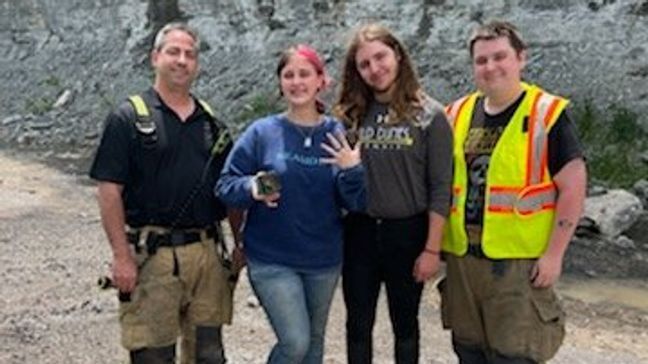 A newly engaged couple poses for a photo with first responders after their vehicle caught fire in Tennessee. (Photo: Williamson Fire-Rescue)