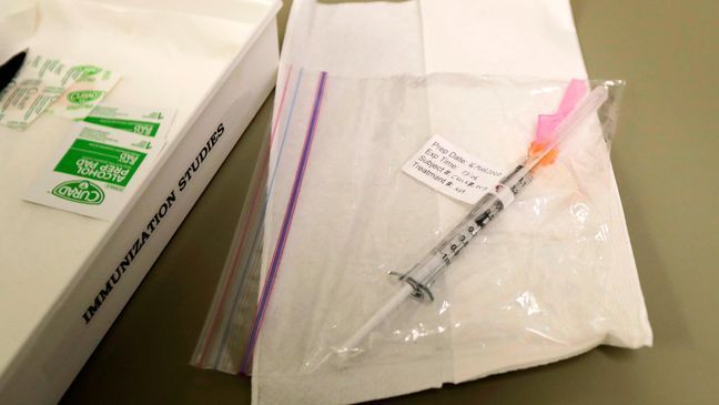 A syringe containing the first shot given in the first-stage safety study clinical trial of a potential vaccine for COVID-19, the disease caused by the new coronavirus, rests on a table, Monday, March 16, 2020, at the Kaiser Permanente Washington Health Research Institute in Seattle. (AP Photo/Ted S. Warren)