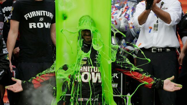 Martin Truex Jr. celebrates with his crew in Victory Lane after winning a NASCAR Cup Monster Energy Series auto race at Chicagoland Speedway in Joliet, Ill., Sunday, Sept. 17, 2017. (AP Photo/Nam Y. Huh)