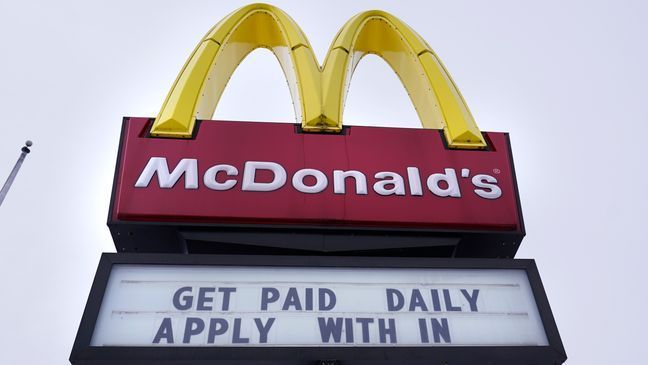 FILE - A sign outside a McDonald's restaurant offers prospective workers an opportunity to get paid daily for their employment, Monday, Feb. 27, 2023, in Salem, N.H. (AP Photo/Charles Krupa)