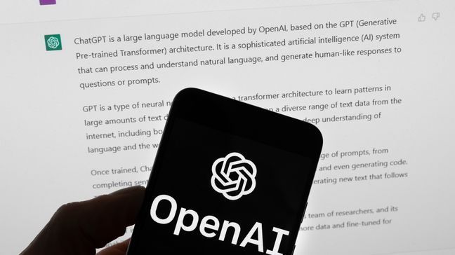 FILE - The OpenAI logo is seen on a mobile phone in front of a computer screen which displays output from ChatGPT, Tuesday, March 21, 2023, in Boston. (AP Photo/Michael Dwyer, File)