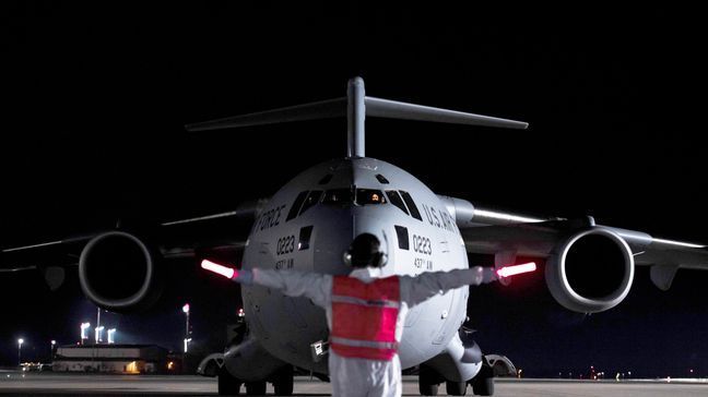 An airman at Ramstein Air Base, Germany, marshals a C-17 Globemaster III transporting three COVID-19 patients from Afghanistan on April 10, 2020. (Photo:{&nbsp;}Air Force Staff Sgt. Devin Nothstine)