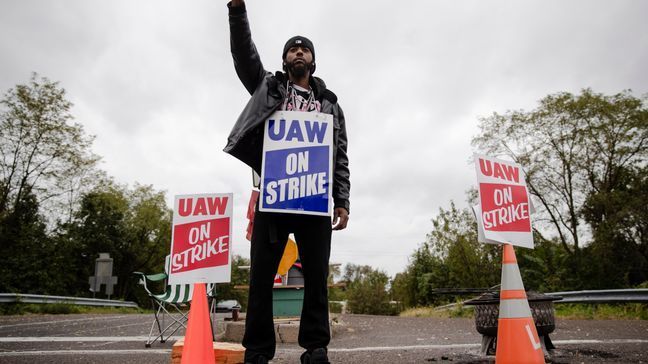 Ryan Piper with the United Auto Workers continues to picket after news of a tentative contract agreement with General Motors, in Langhorne, Pa., Wednesday, Oct. 16, 2019. Bargainers for General Motors and the United Auto Workers reached a tentative contract deal on Wednesday that could end a monthlong strike that brought the company's U.S. factories to a standstill. (AP Photo/Matt Rourke)