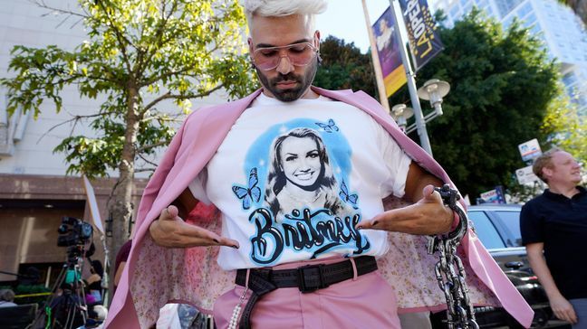 New Jersey performer and Britney Spears supporter "Brennyboombox" shows off his T-shirt outside a hearing concerning the pop singer's conservatorship at the Stanley Mosk Courthouse, Friday, Nov. 12, 2021, in Los Angeles. (AP Photo/Chris Pizzello)