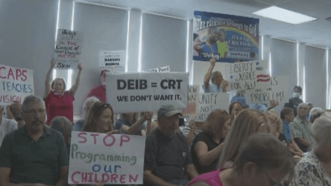 Parents protest critical race theory at a Traverse City school board meeting. (Photo: WPBN)