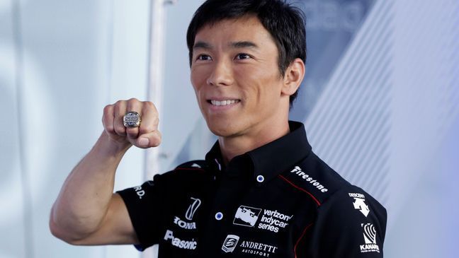 Takuma Sato, the 2017 Indianapolis 500 winner, poses for photos with his championship ring before ringing the opening bell at the Nasdaq MarketSite, in New York's Times Square, Tuesday, May 30, 2017. (AP Photo/Richard Drew)