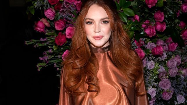 FILE - Lindsay Lohan appears the Christian Siriano Fall/Winter 2023 fashion show in New York on  Feb. 9, 2023. Lohan is expecting her first child. The “Mean Girls” star announced her pregnancy on Instagram on Tuesday.  (Photo by Charles Sykes/Invision/AP, File)