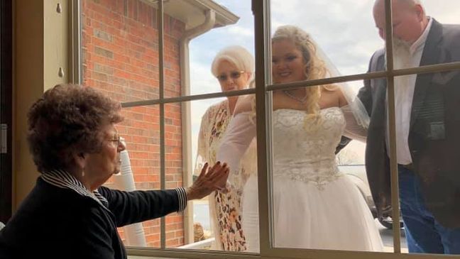 Woman visits grandma through window of assisted living home in her wedding gown (KTUL)