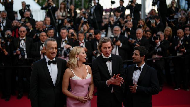 Tom Hanks, from left, Scarlett Johansson, director Wes Anderson and Jason Schwartzman pose for photographers upon arrival at the premiere of the film 'Asteroid City' at the 76th international film festival, Cannes, southern France, Tuesday, May 23, 2023. (AP Photo/Daniel Cole)