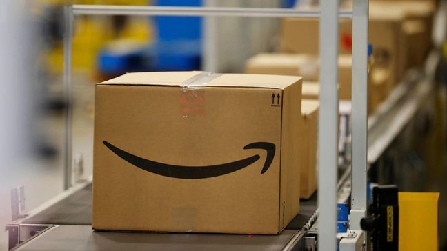 FILE - This May 3, 2018, photo shows boxes on a conveyor belt during a tour of the Amazon fulfillment center in Aurora, Colo. (AP Photo/David Zalubowski)